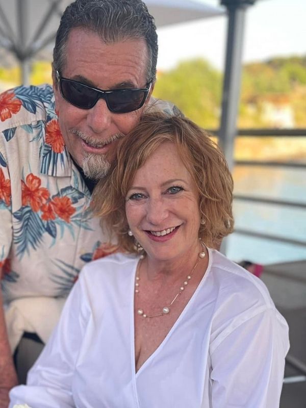 a couple with female wearing modern pearl necklace & earrings